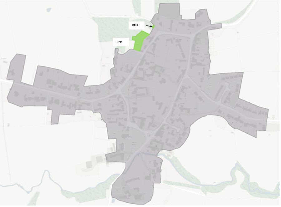 Aerial map with PM1 and PM2 marked near a green area in an urban layout.