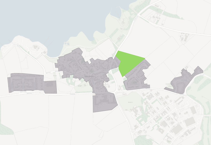 A map with grey-shaded urban areas and a green triangular park, surrounded by roads and rural landscapes.