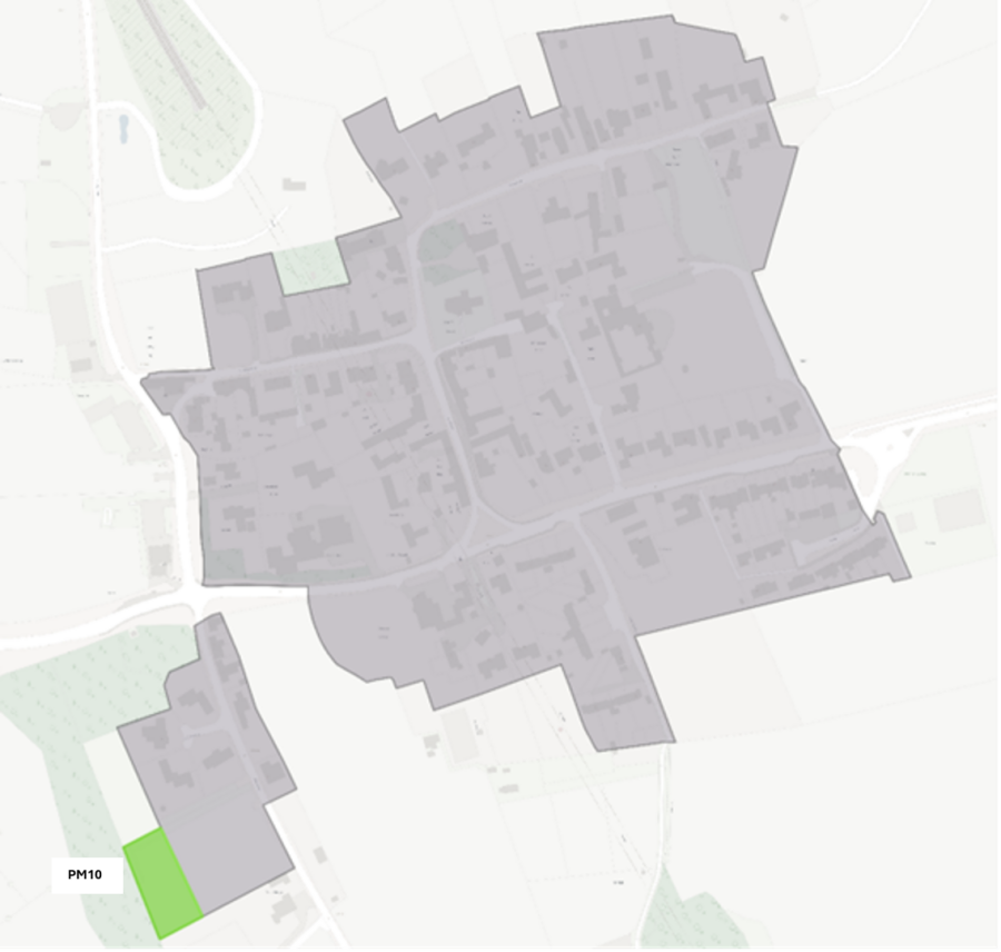 Aerial view of a residential neighbourhood with a highlighted green rectangular area labelled PM10 in the bottom left corner, surrounded by grey buildings and green spaces.